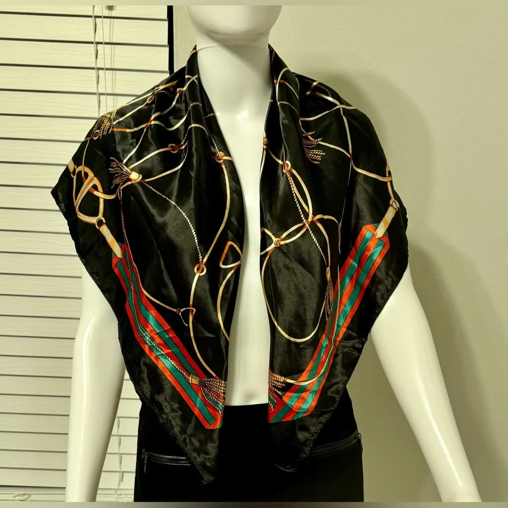 Fashionable women's black scarf with a chain and print. Polyester.